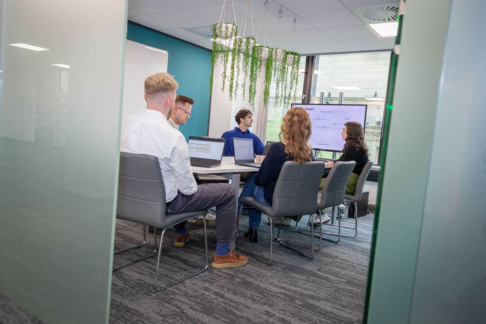 international SEO team having a meeting in an office around a desk